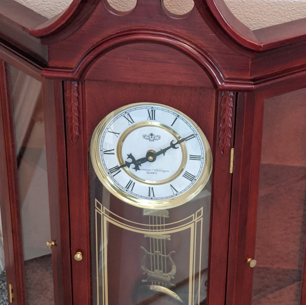 Wooden wall clock with glass cabinet